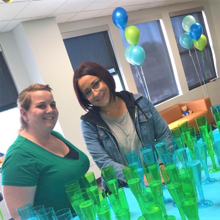 Two IntelyCare employees celebrating during a company party