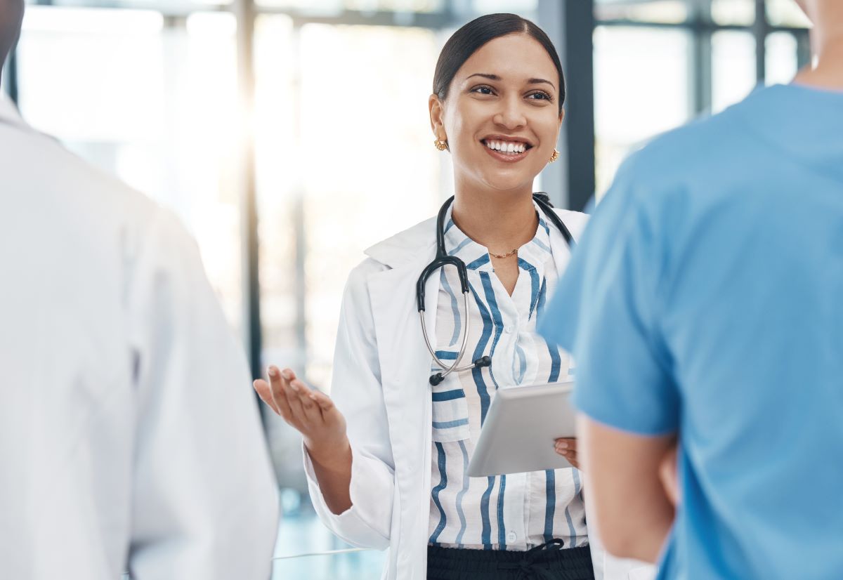 A healthcare administrator speaking with her staff.