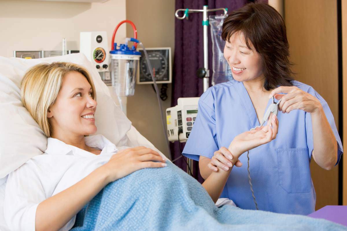 Nurse midwife helps a patient