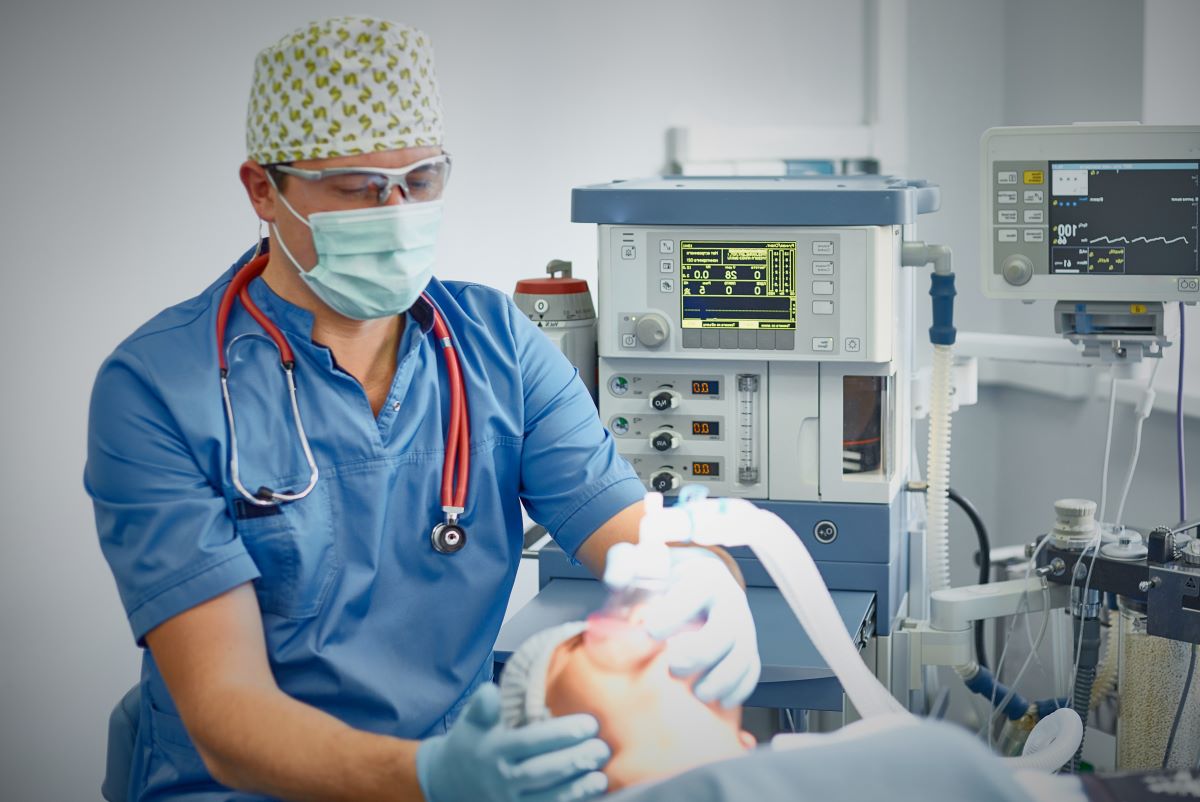 A nurse anesthetist helps prep a patient for surgery.