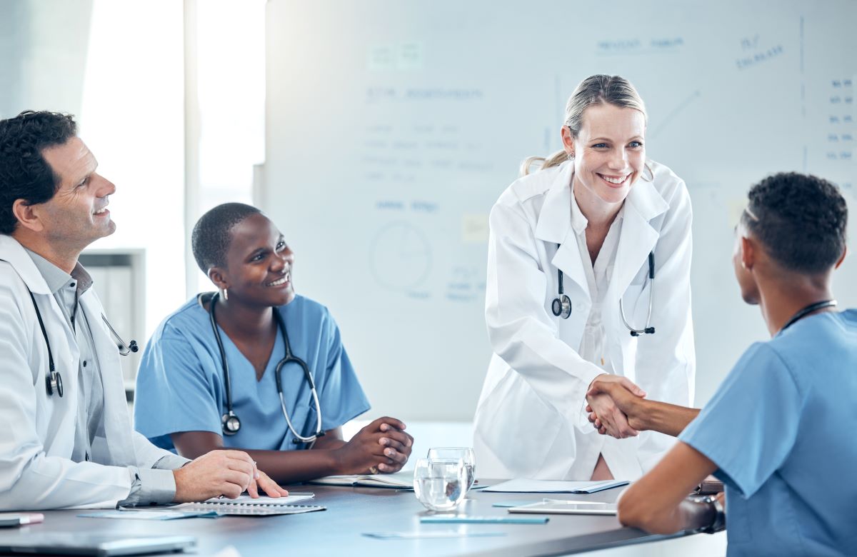 After asking a long string of RN interview questions, a nurse manager shakes the hand of her new hire.