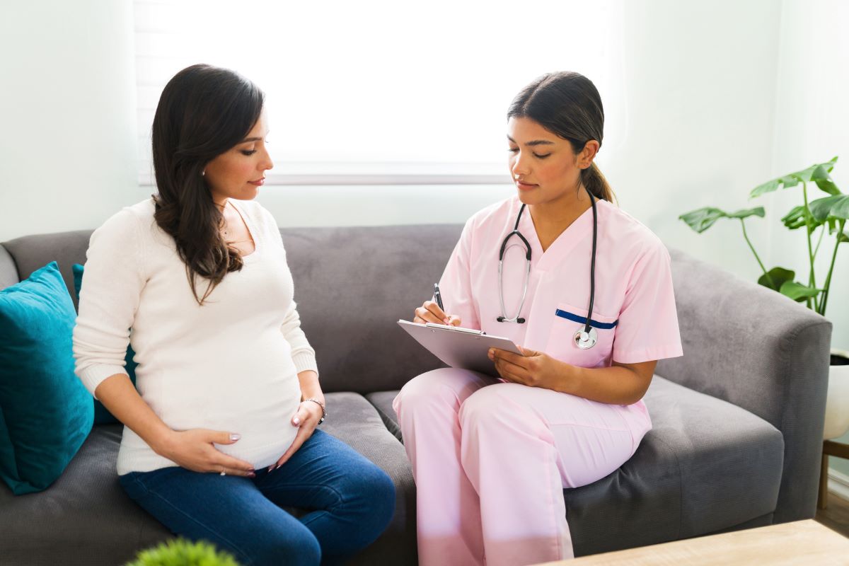 A nurse midwife meets with a client to discuss their birthing plan.
