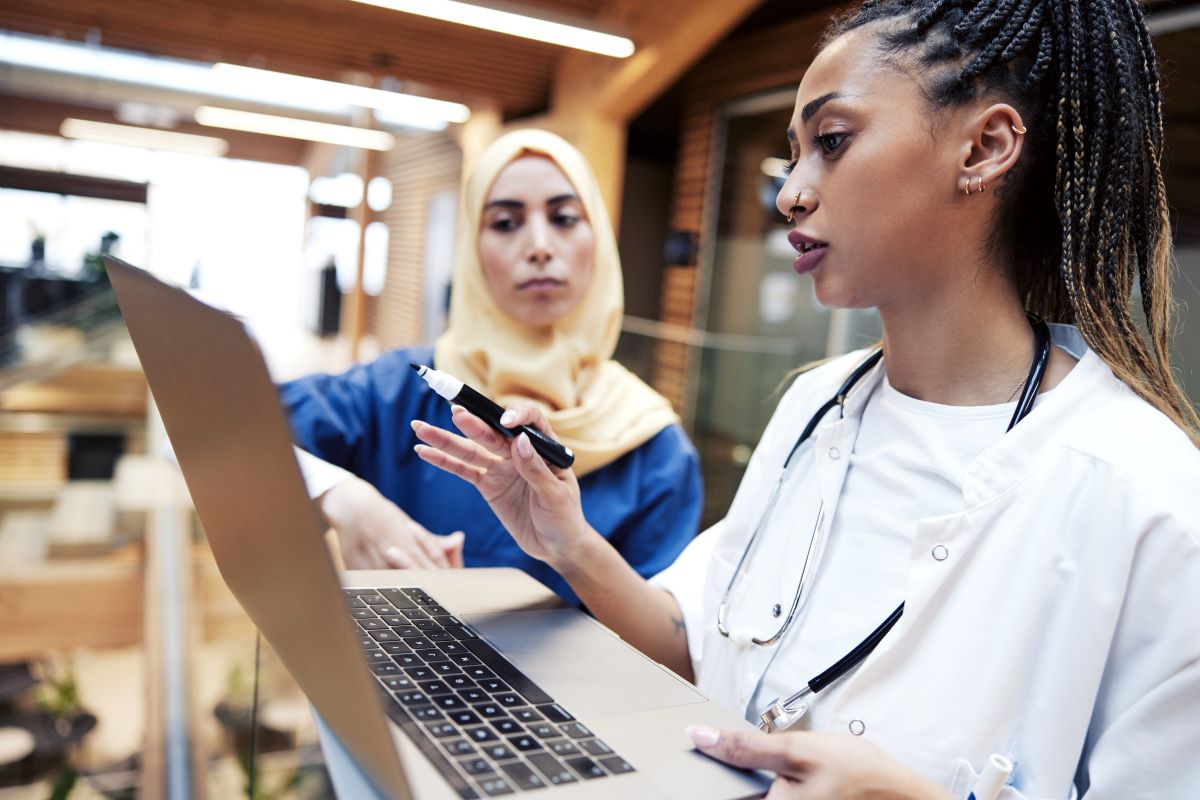 A nurse who's ending her shift goes over the nursing handoff report with her replacement.