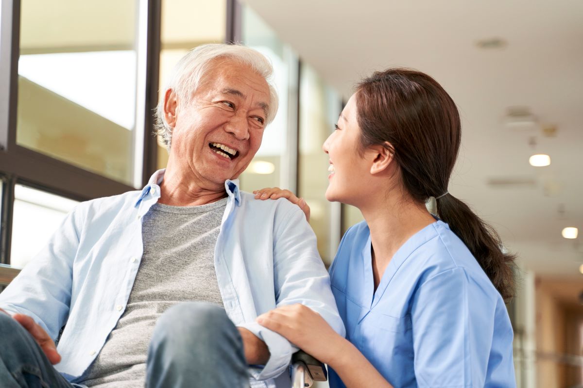A nurse spends quality time with a nursing home resident.