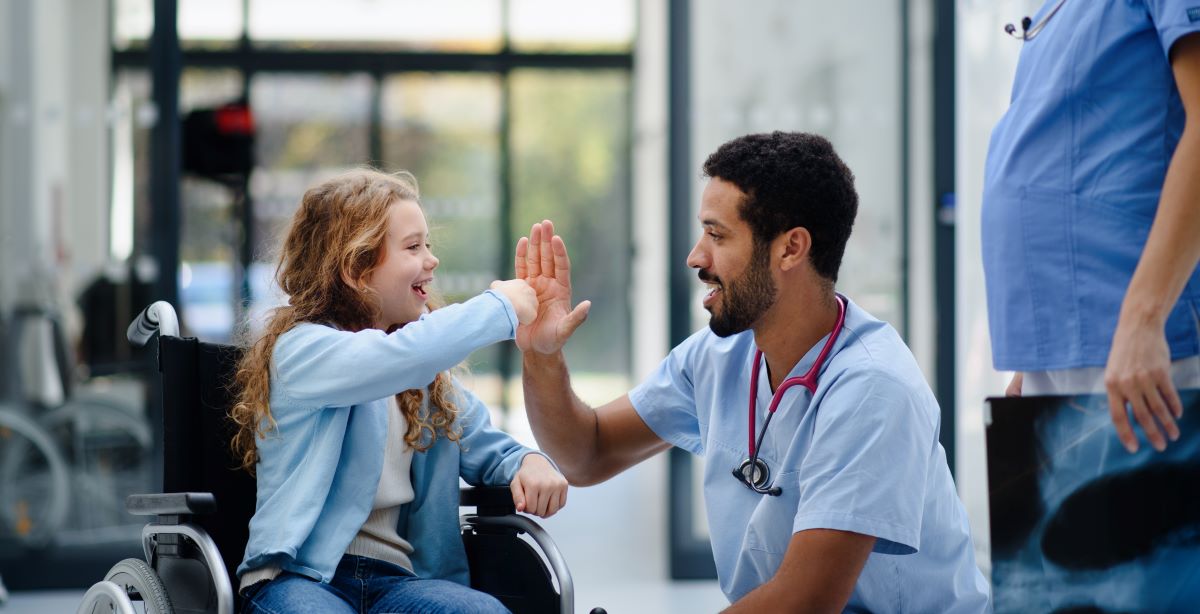 Pediatric nurse giving a high five to a patient