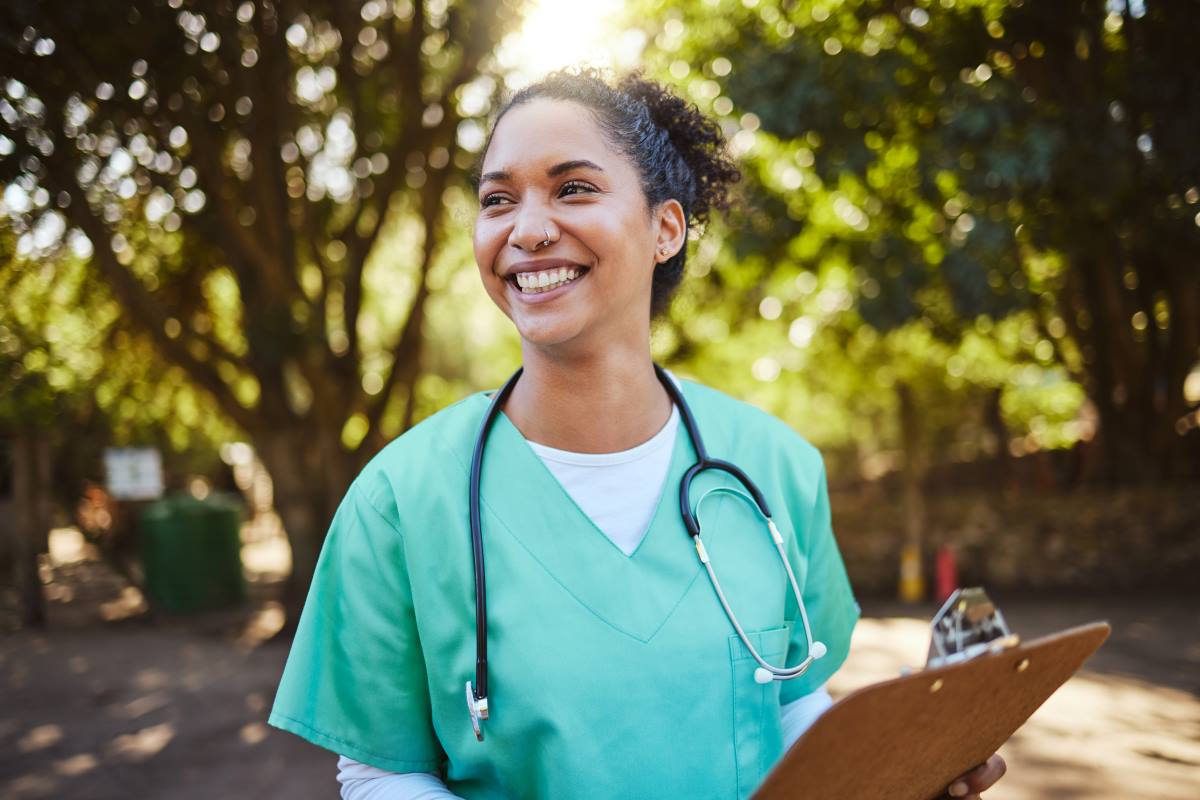 Smiling nurse in a park