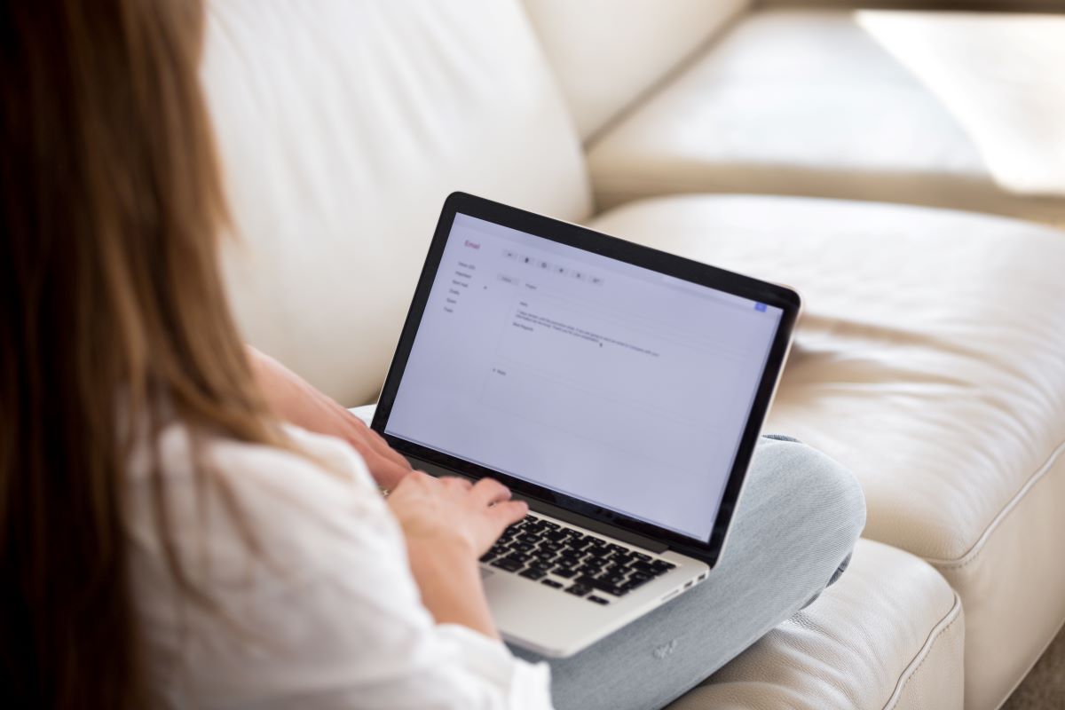 Person writing a cover letter on a laptop