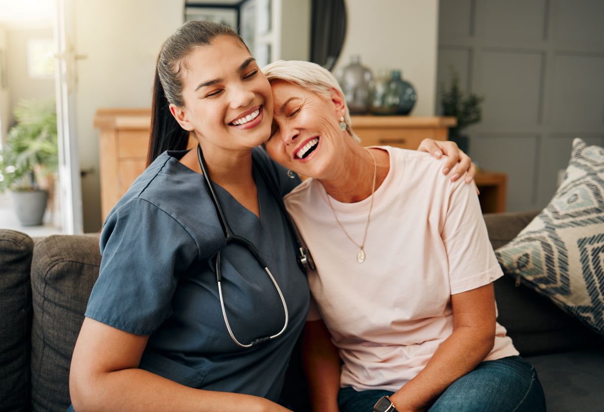 A home health nurse shares a tender moment with one of her patients.