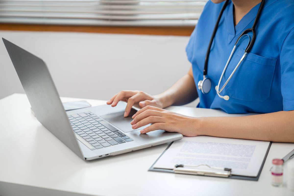 Nurse works on their labor and delivery nurse cover letter to prepare for a new job.