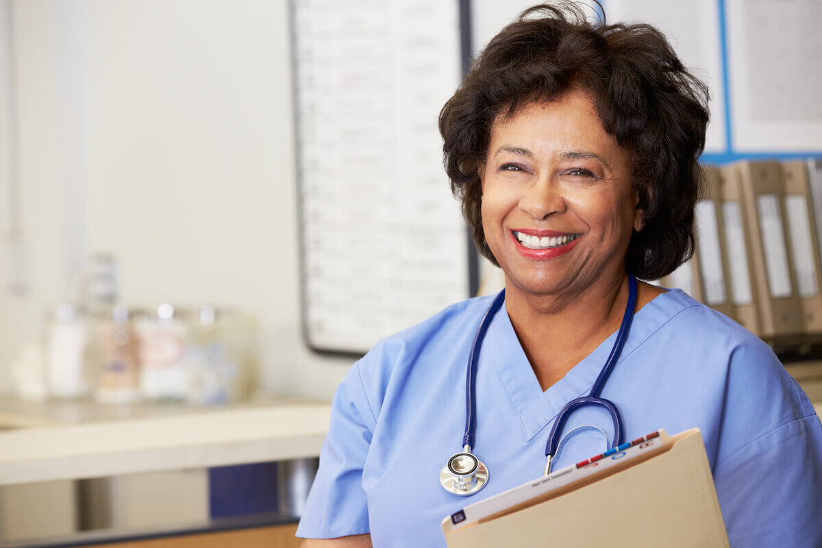 African American nurse smiling after completing Ohio board of nursing license renewal.