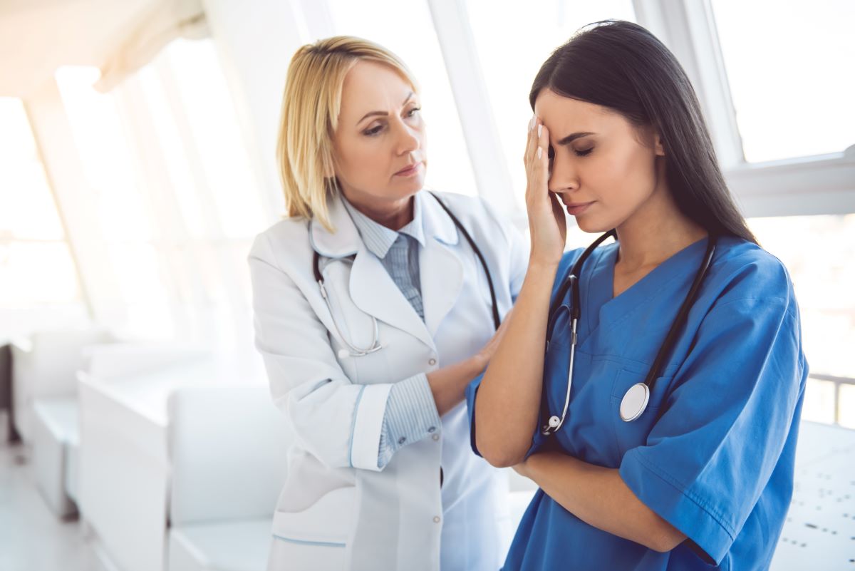 A woman dealing with workplace bullying in nursing gets support from a manager.