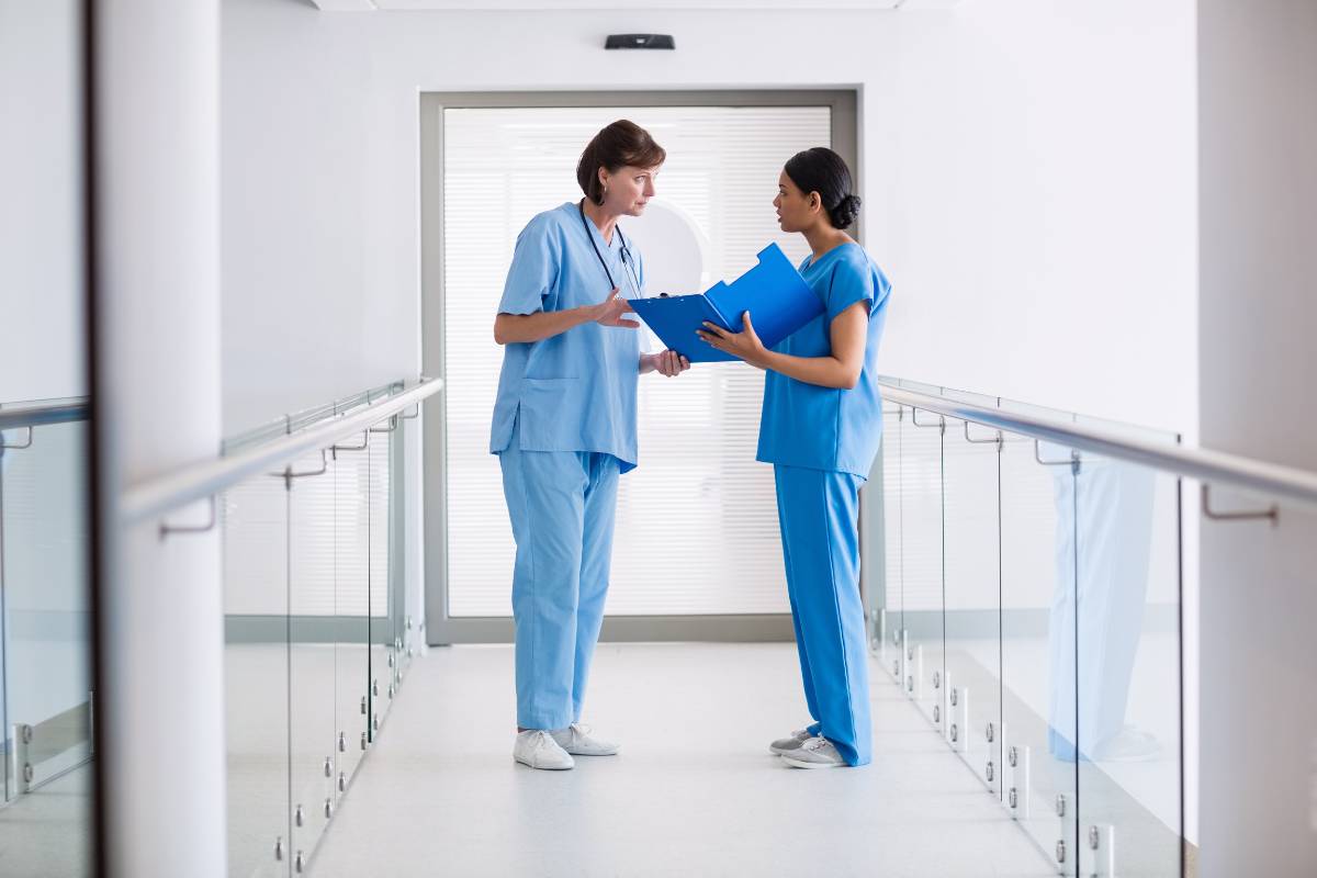 Two nurses put assertive communication in nursing into practice.