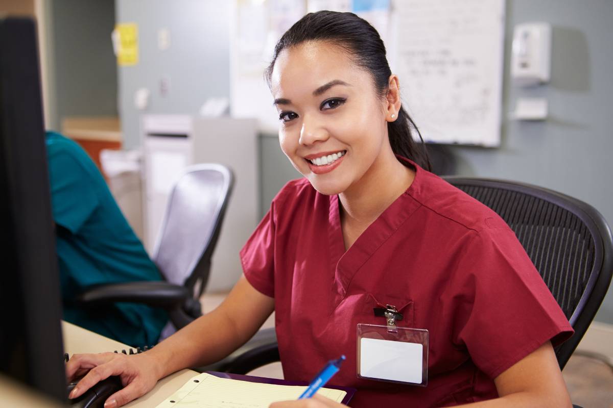 A nurse in red scrubs demonstrates: "What is a telemetry nurse?"