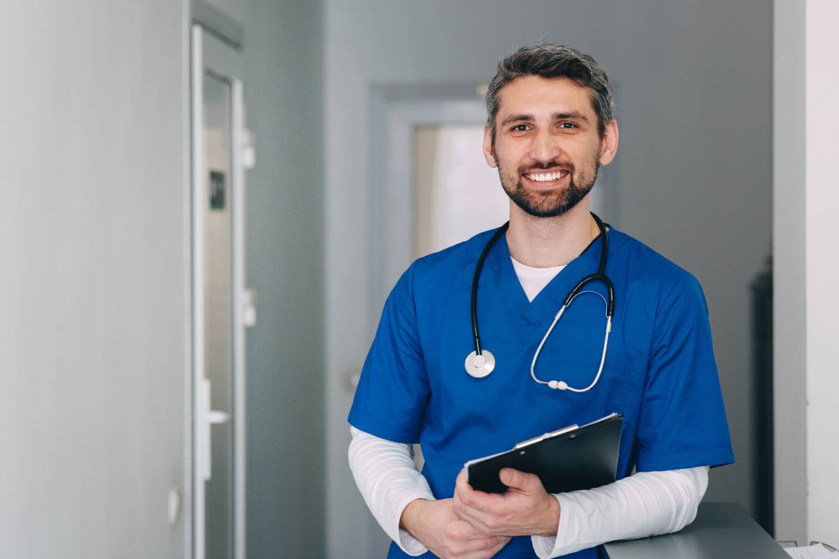 A nurse in blue scrubs answers the question: What is a triage nurse?