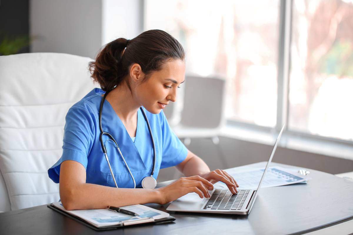 Woman in blue scrubs demonstrates how to work from home as a nurse.