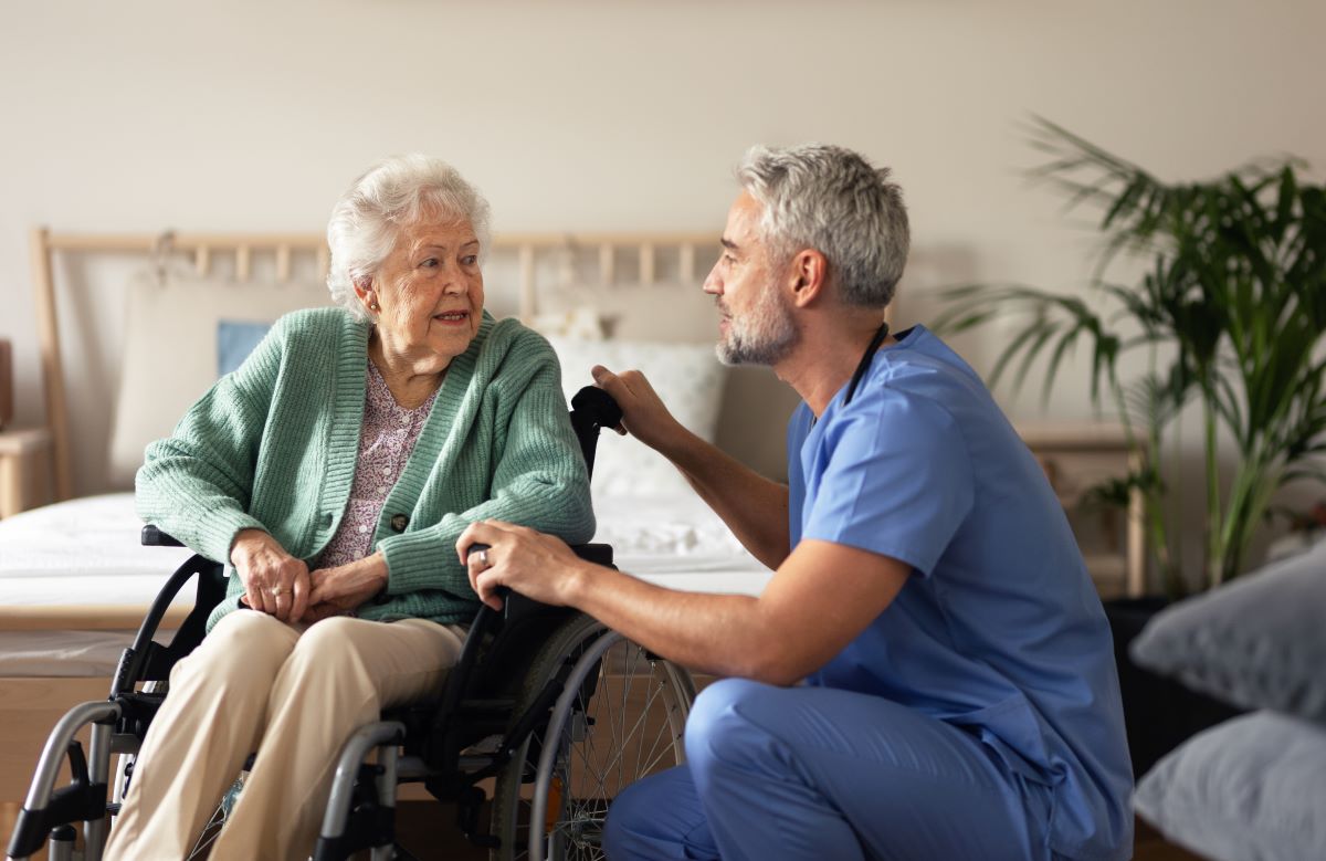 A home care nurses assists one of his patients at her home.
