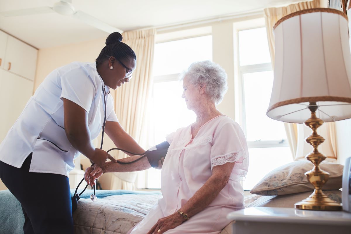 A nurse attends to one of the residents in a nursing home.