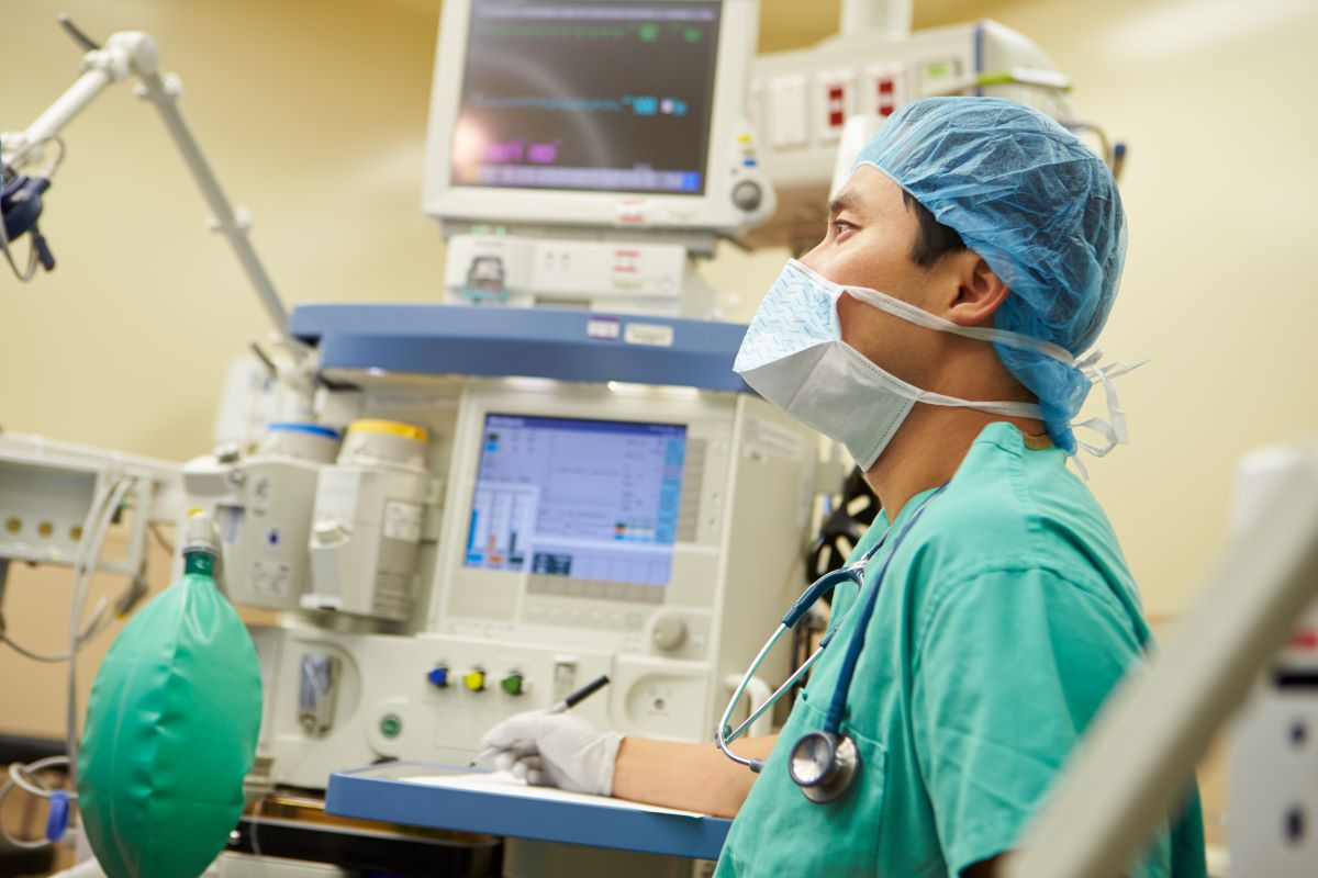 A nurse anesthetist takes while monitoring a patient's status during surgery.