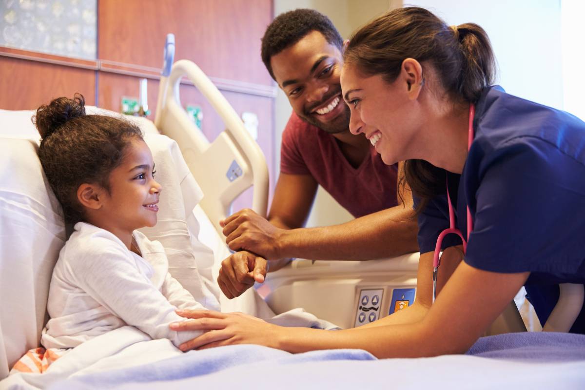 A PICU nurse greets her patient.