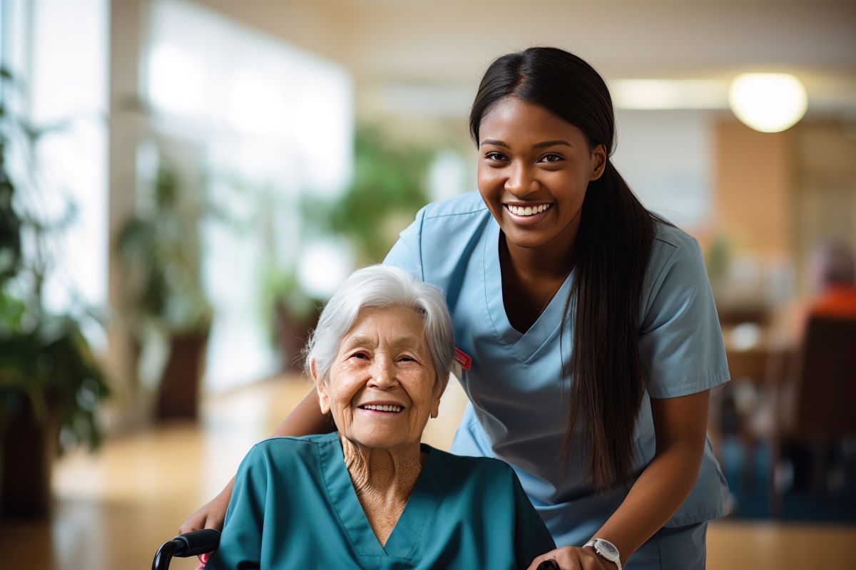 A CNA helps one of her patients move to another room in the facility.