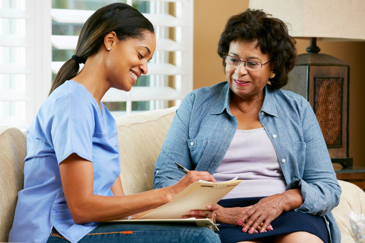 A nursing home residents talks to a nurse prior to a state ombudsman review.
