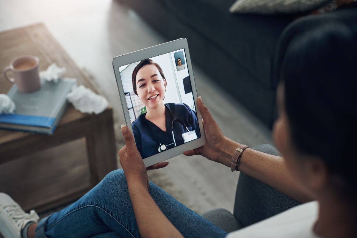 A virtual nurse meets with a patient who has been discharged to check on her progress.