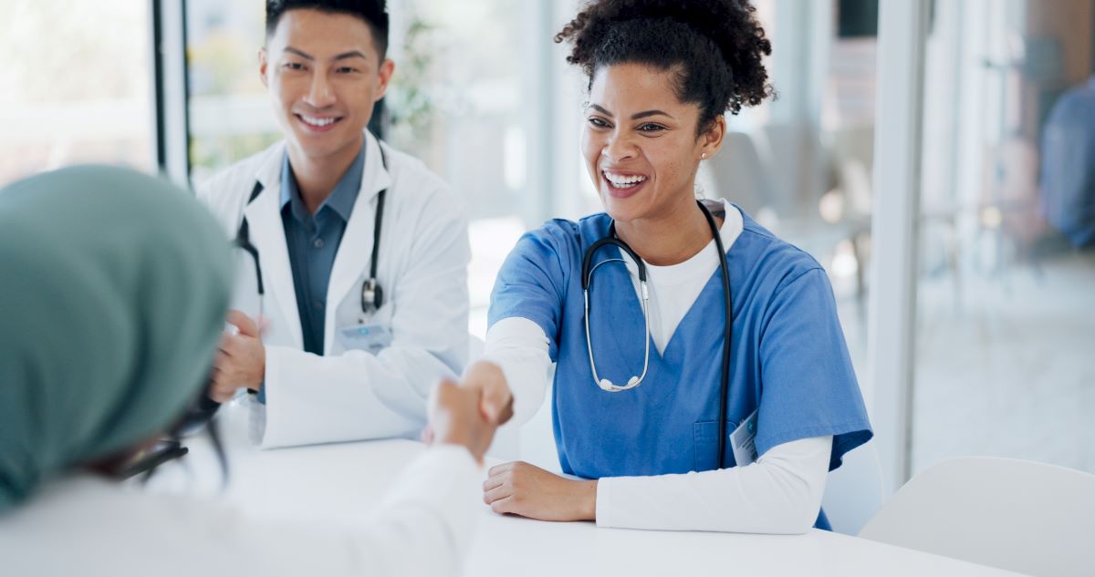 A newly hired nurse goes through the healthcare onboarding checklist with her new supervisor.