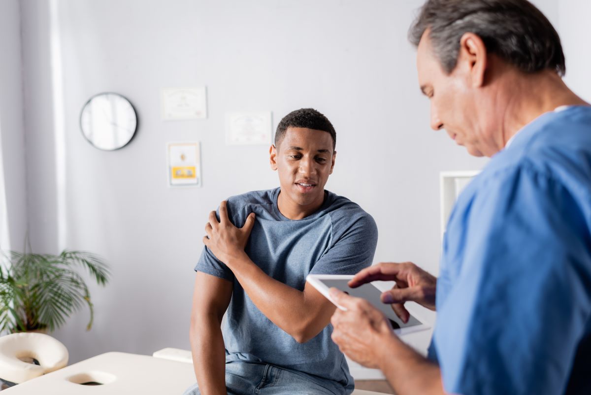 A nurse assesses his patient using a pain scale.