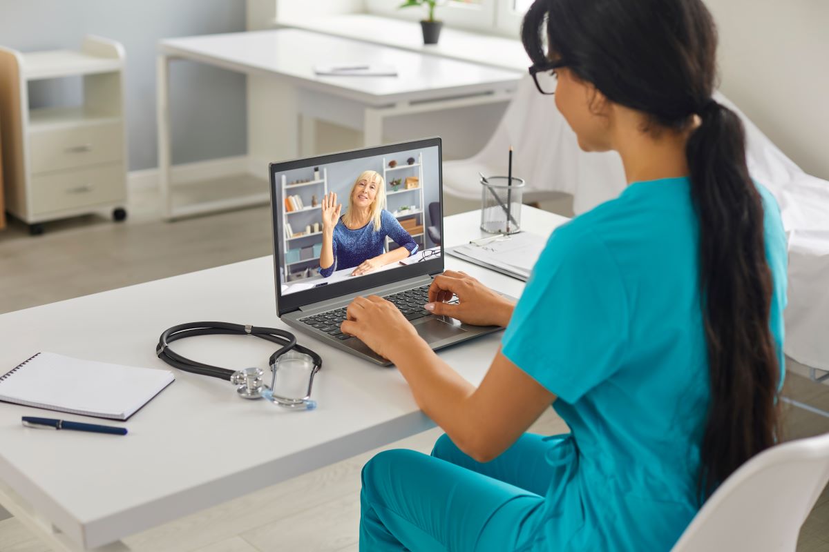 A nurse meets with a patient via Zoom.