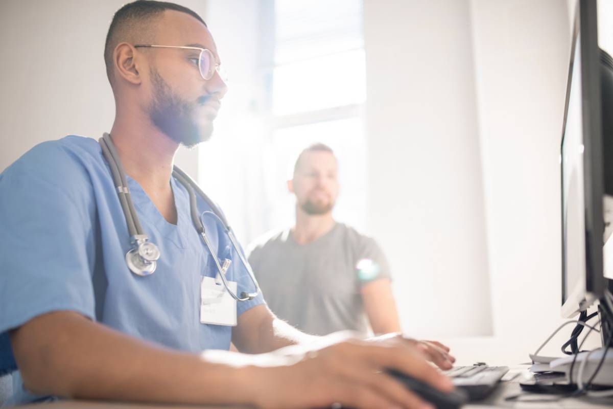 An occupational health nurse works with a patient.