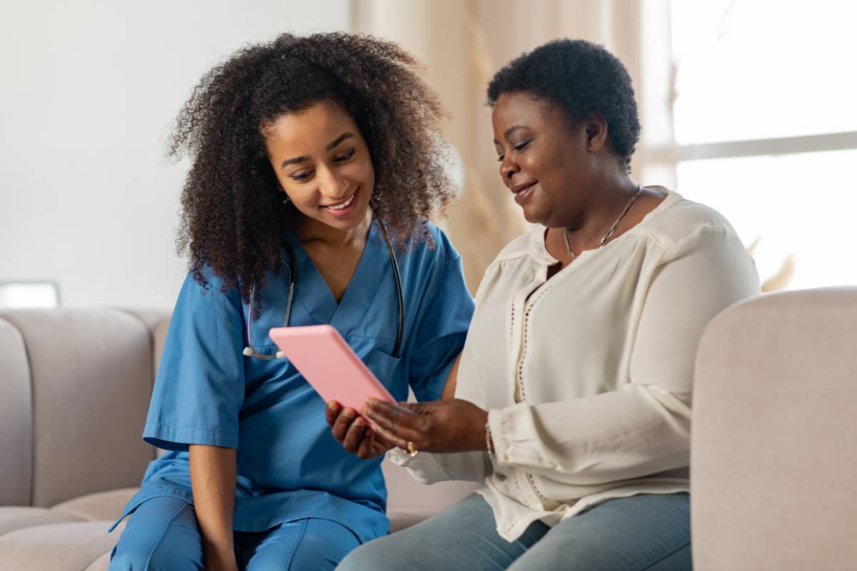 A nurse navigator assists a patient.