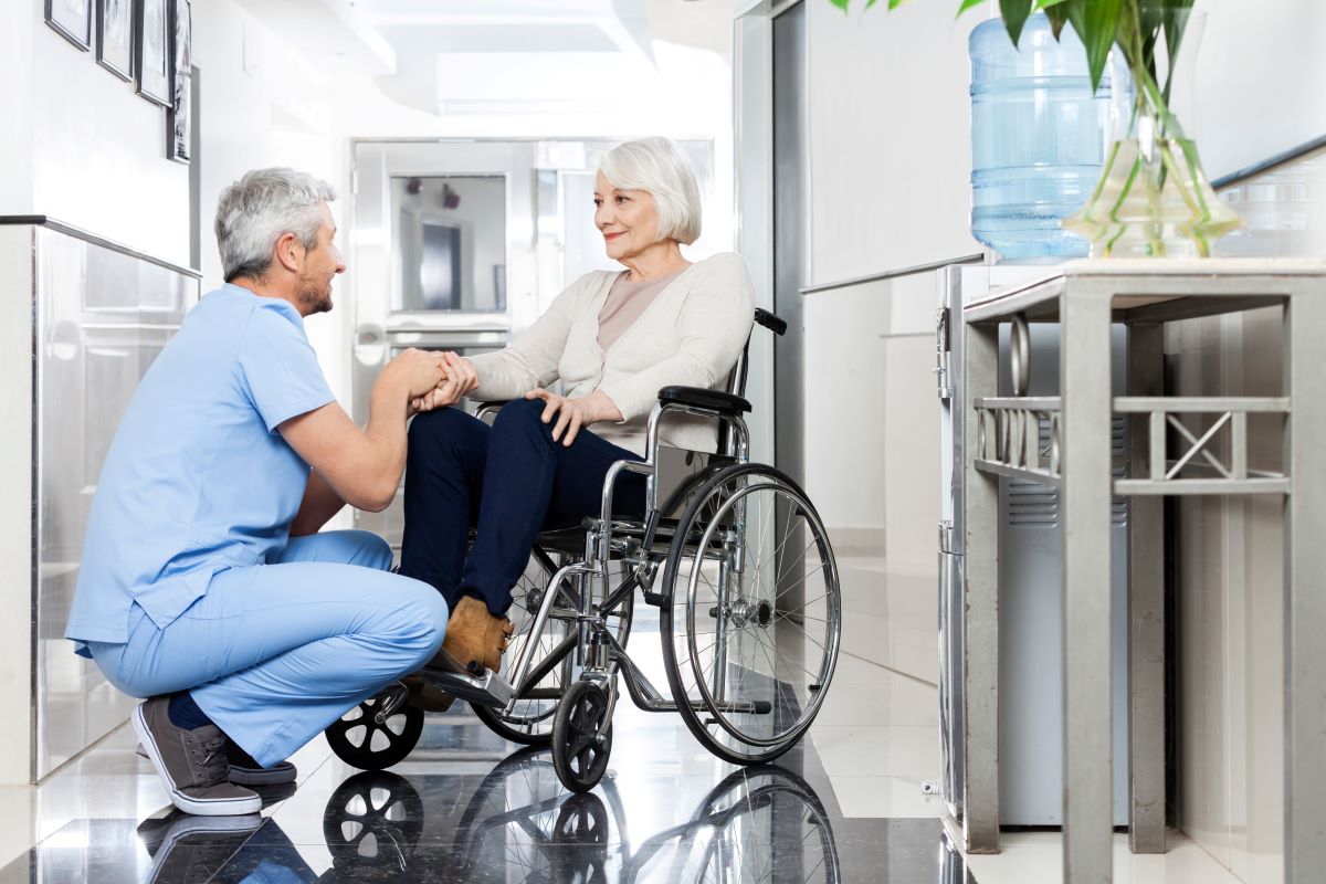 A nurse spending quality time with one of his LTC residents.