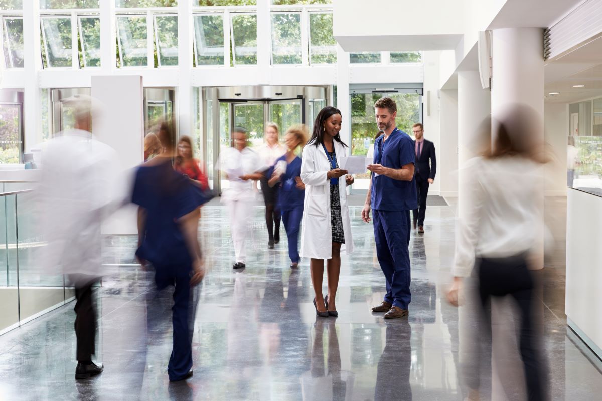 Scene from the hallway of a busy hospital.