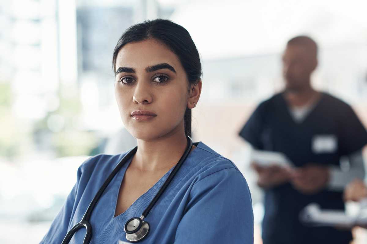Female nurse looking worried about workplace violence in nursing