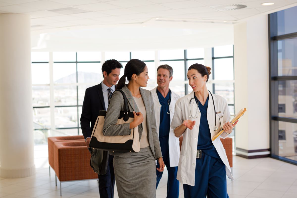 A group of hospital executives meets to discuss branding strategies.