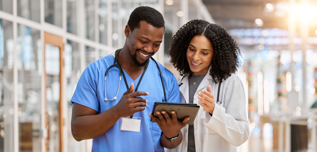 A nurse and a physician check nursing job sites for new recruits.