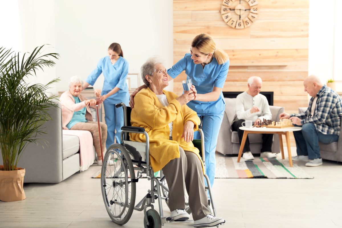 A nurse assists a nursing home resident.