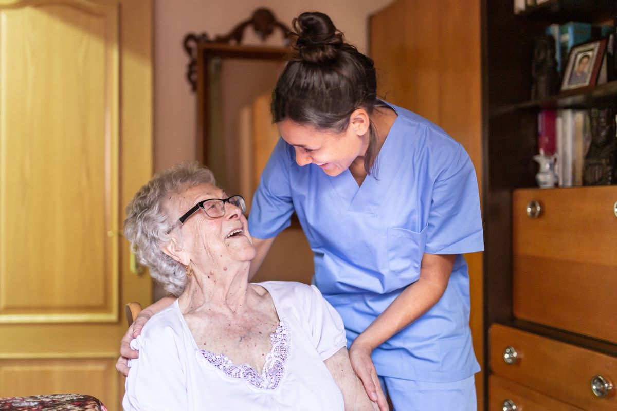 A nurse shares a moment with a resident.