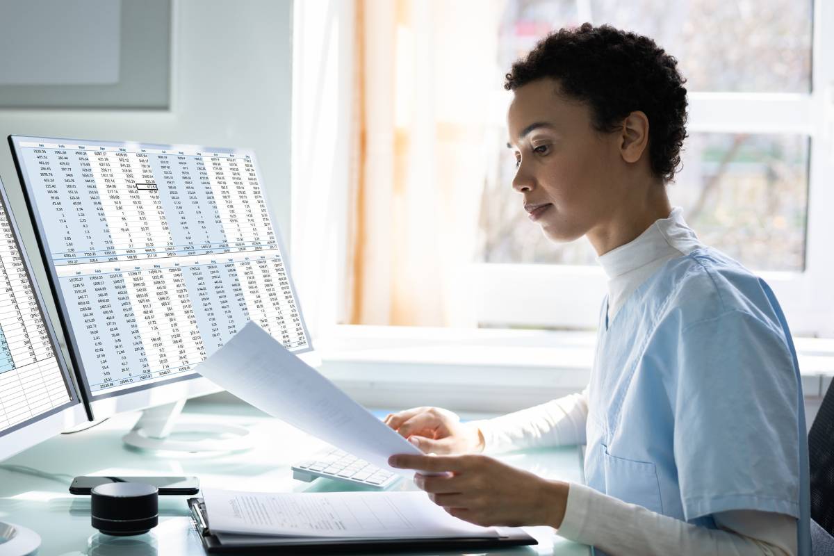 A nurse reviews her documents as she practices financial planning for nurses.