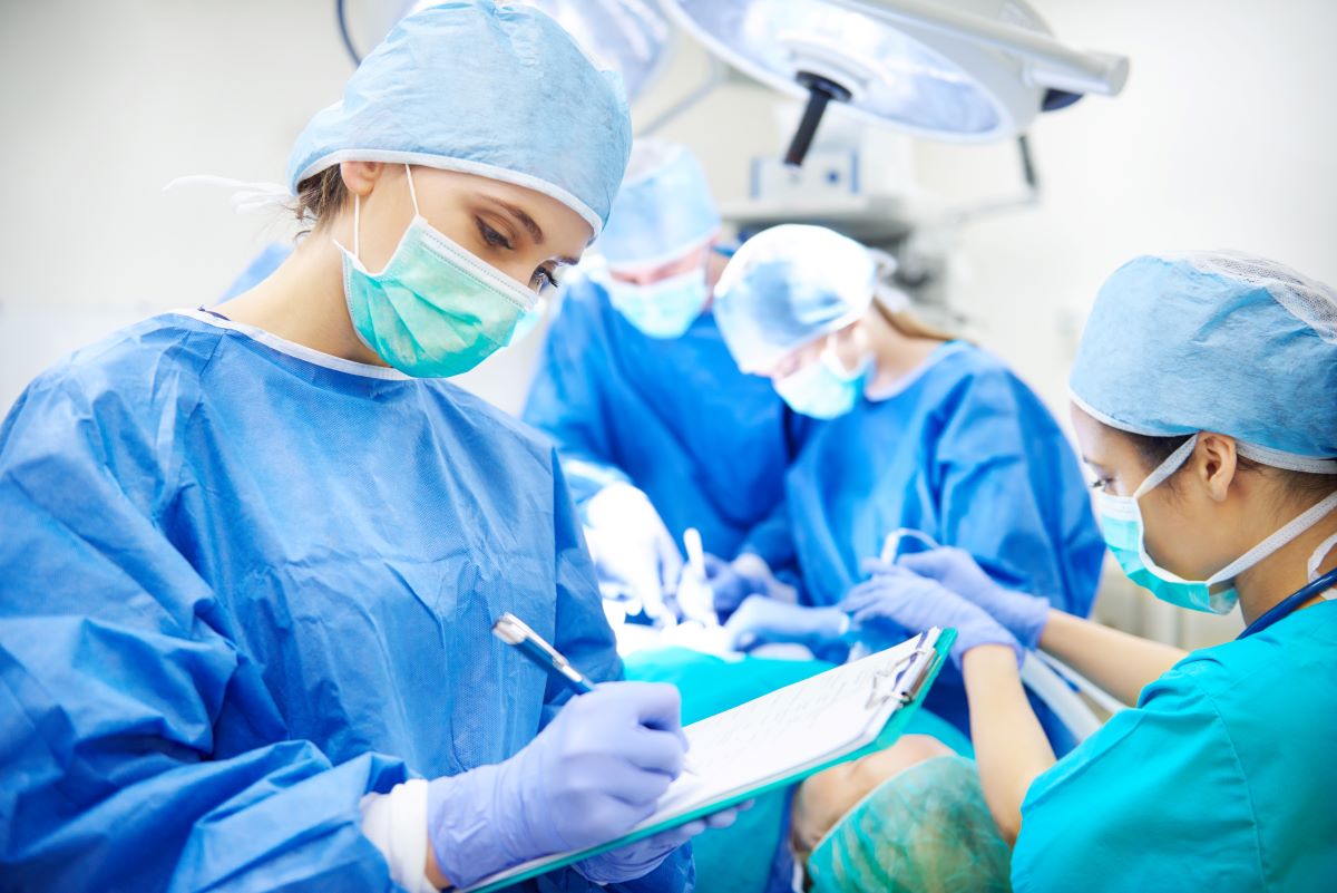 Medical-surgical nurse taking notes in an operating room during a procedure
