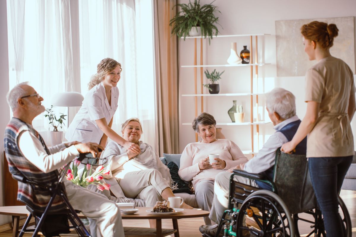 Nursing home residents talking together around a table