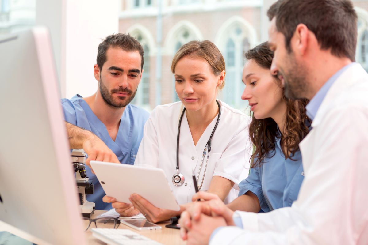 Medical staff talking at a desk in an office