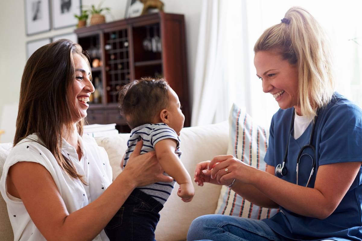 A certified breastfeeding counselor meets with a mother and baby.