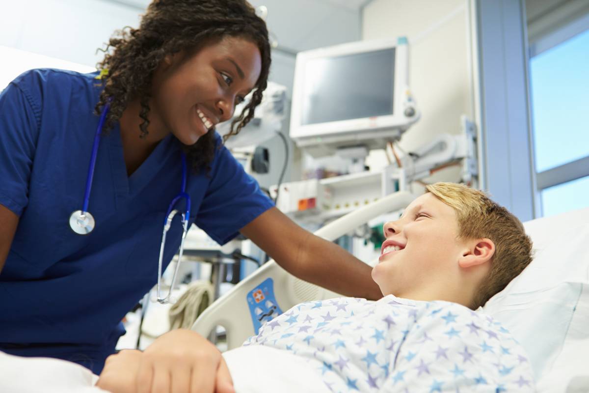 An emergency nurse practitioner assesses a young boy in the ER.
