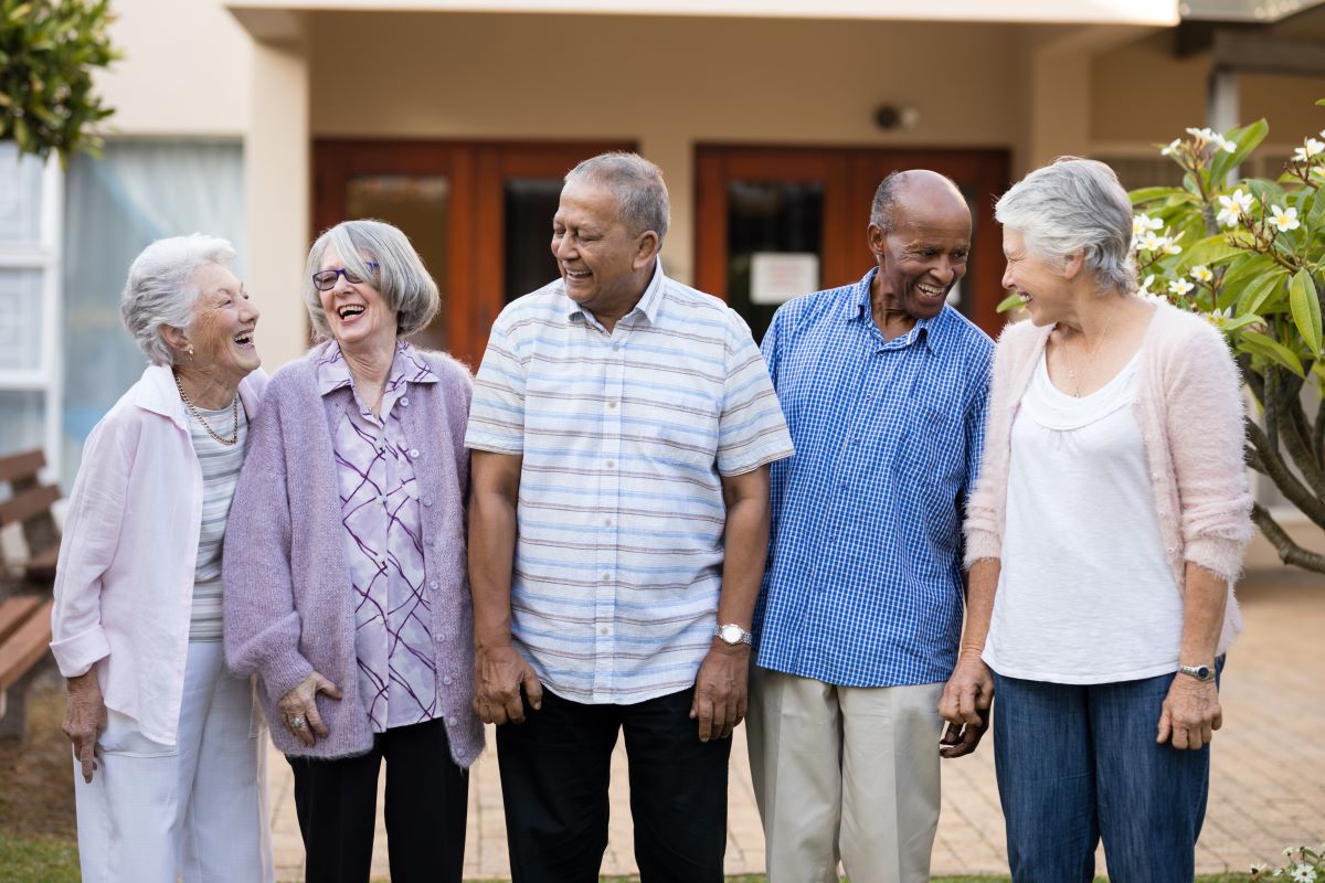 Five nursing home residents enjoy some time together outside.