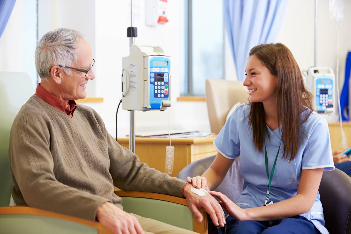 An oncology nurse practitioner speaks with a patient.