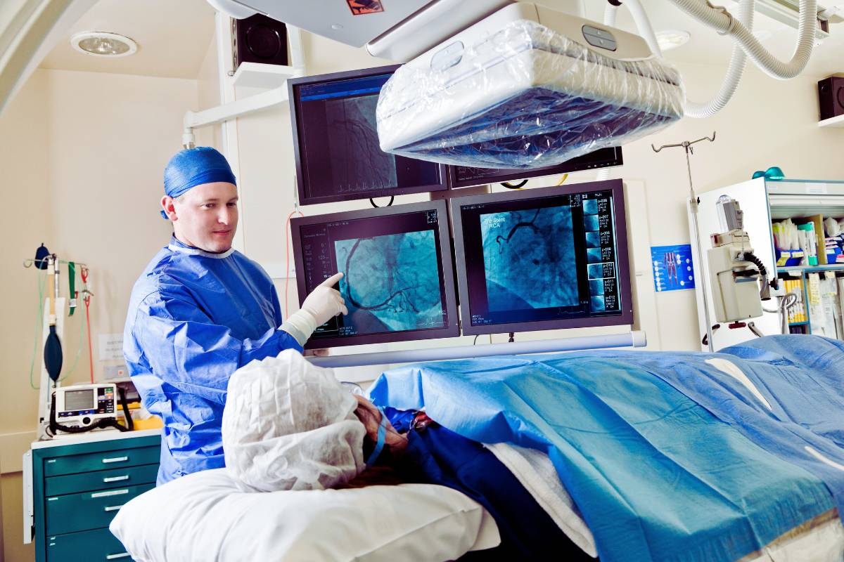 A nurse uses their RCIS certification skills during a cardiac catheterization procedure.