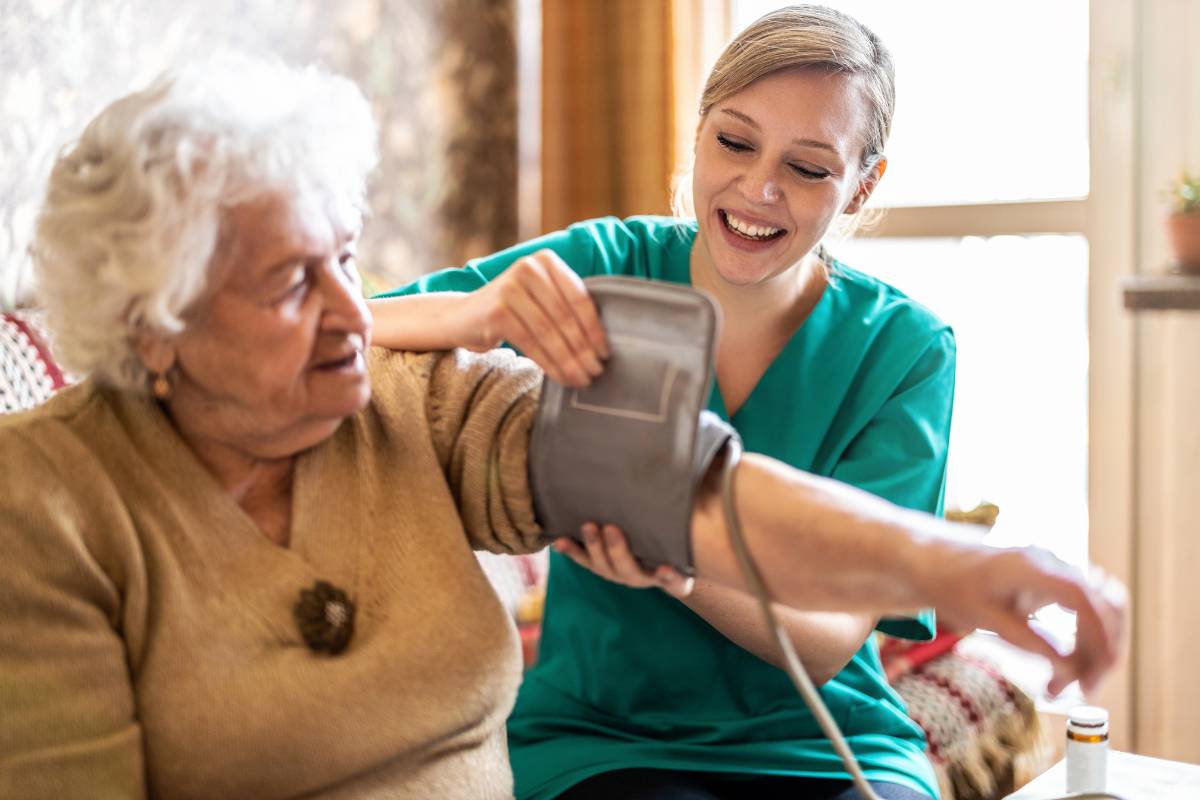 A nurse displays her home health nurse resume skills while assisting a patient.