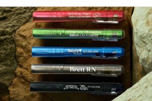 Customized pen lights with names on them.